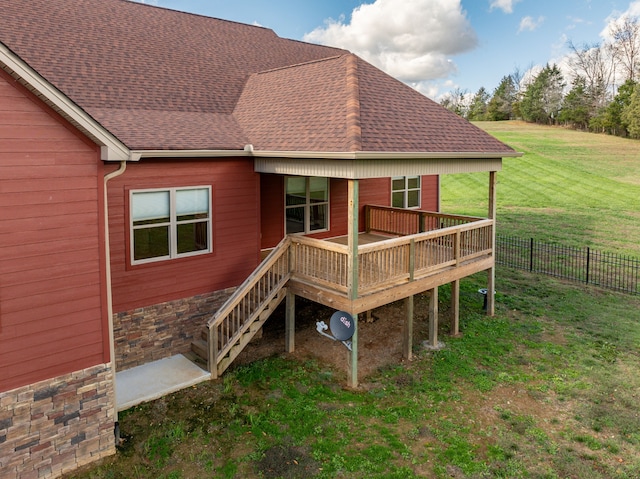 back of property featuring a lawn and a wooden deck