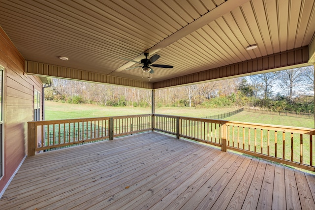 deck with a lawn and ceiling fan