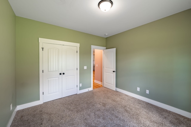 unfurnished bedroom featuring carpet floors and a closet