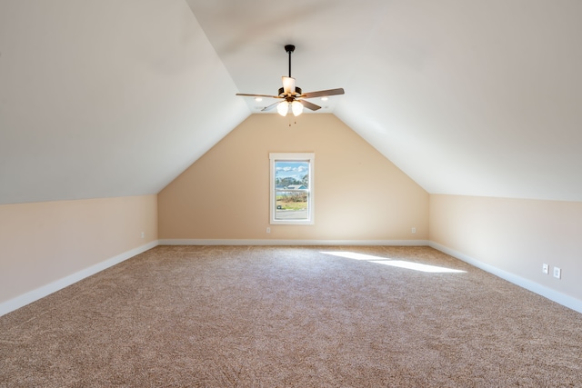 additional living space with ceiling fan, carpet, and vaulted ceiling