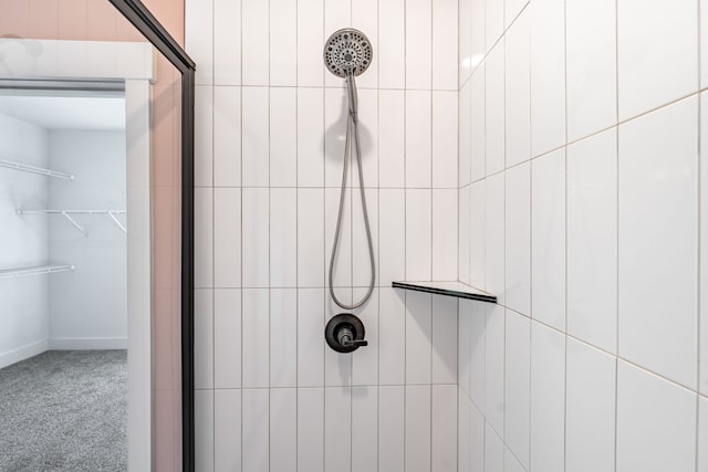 bathroom with a tile shower