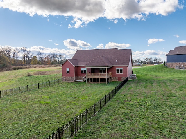 back of property featuring a yard, a rural view, cooling unit, and a wooden deck