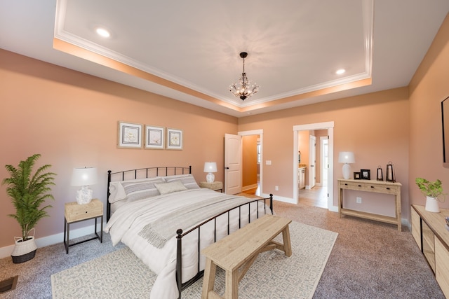 carpeted bedroom with a raised ceiling, ornamental molding, and an inviting chandelier