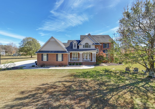 view of front of house with covered porch and a front yard