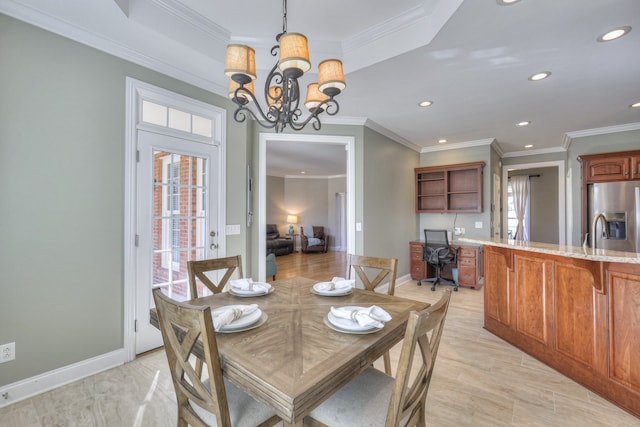 dining area with crown molding and a notable chandelier