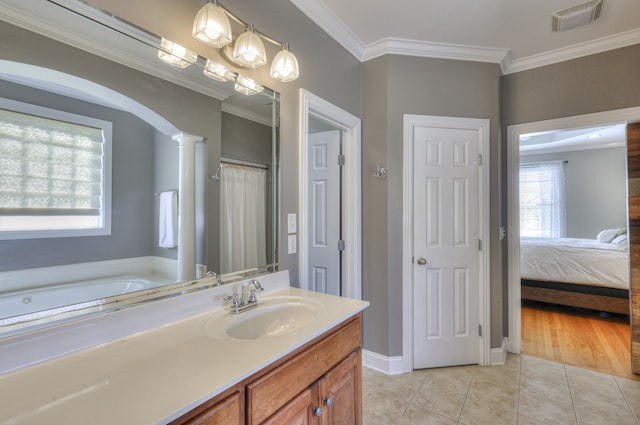 bathroom featuring vanity, a bath, tile patterned floors, crown molding, and decorative columns