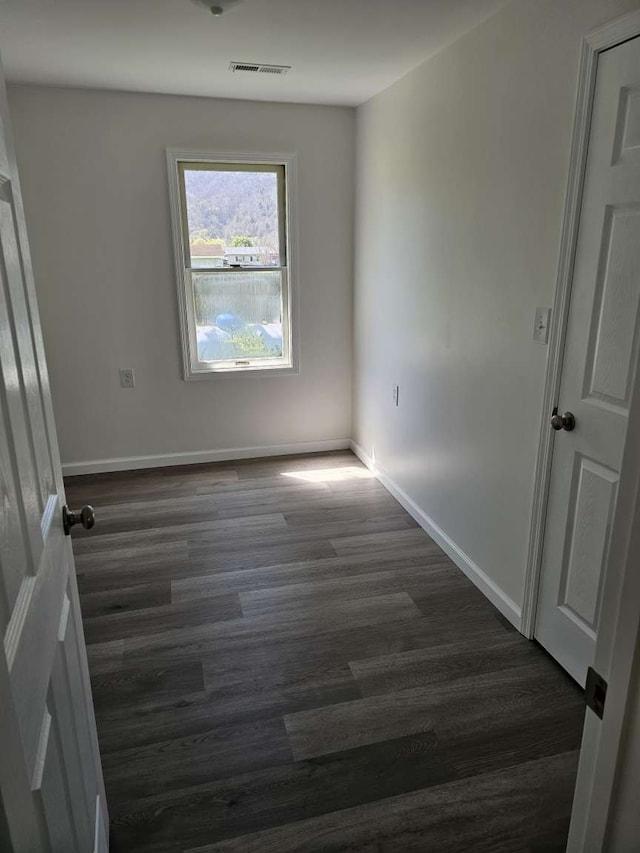 spare room with dark hardwood / wood-style flooring