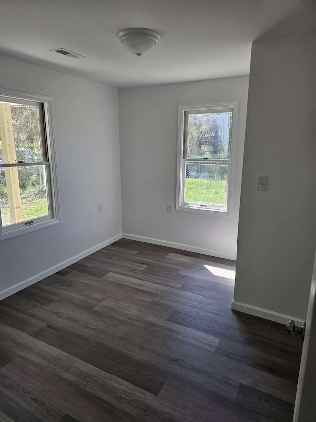 spare room with dark hardwood / wood-style flooring