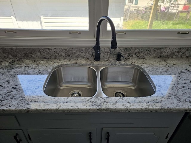 interior details featuring gray cabinets and sink