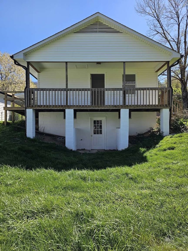 rear view of property with a lawn