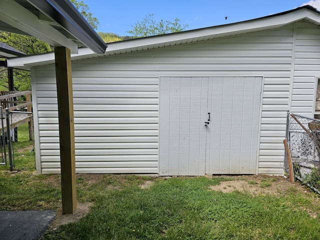 view of outbuilding featuring a lawn