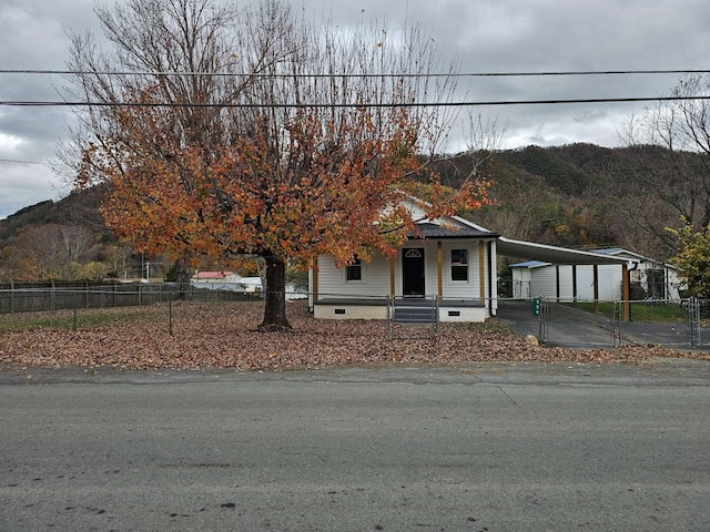 view of front facade with a mountain view and a carport