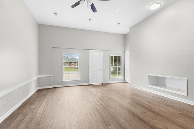 unfurnished living room featuring ceiling fan and light hardwood / wood-style floors