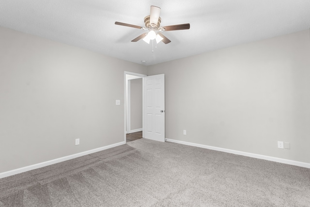 empty room featuring ceiling fan and carpet floors