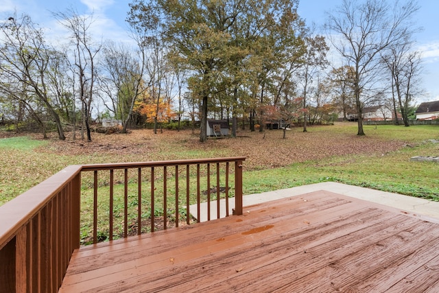 wooden deck featuring a yard