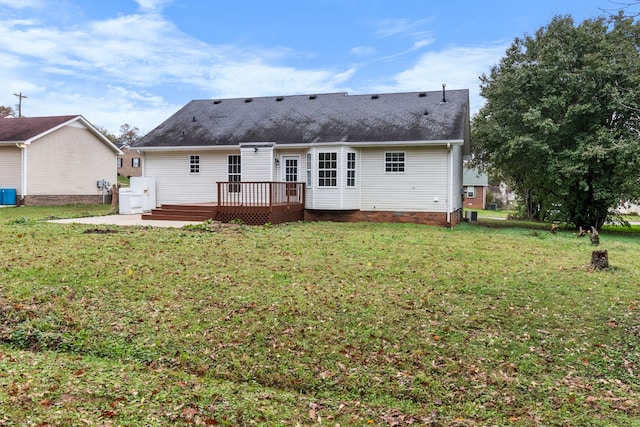 rear view of property featuring a yard and a wooden deck