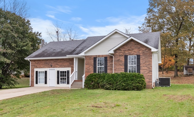 view of front of property with central AC and a front lawn