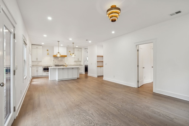 unfurnished living room featuring hardwood / wood-style flooring