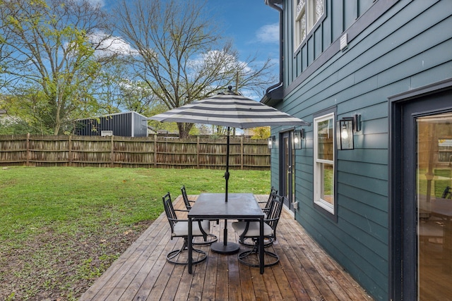 wooden terrace with a lawn