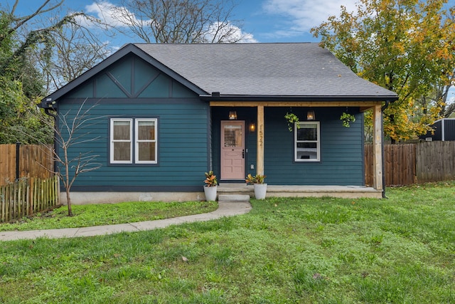 view of front of house with covered porch and a front yard