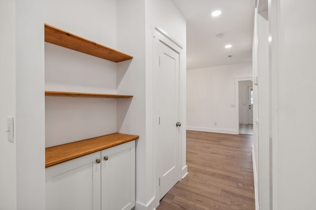 hallway with light hardwood / wood-style flooring