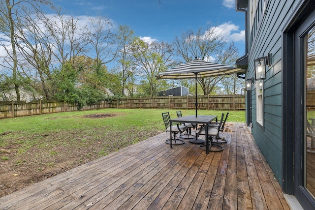 wooden terrace with a lawn