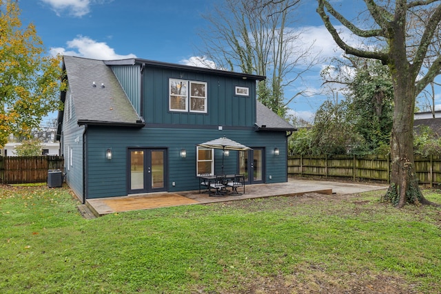 back of house with a patio area, a yard, and central AC