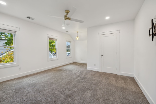 carpeted empty room featuring ceiling fan