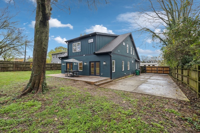 back of property featuring french doors, a patio, and a lawn