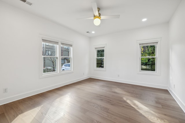 spare room featuring hardwood / wood-style floors and ceiling fan