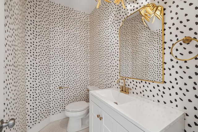 bathroom featuring tile patterned flooring, vanity, and toilet