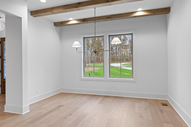 unfurnished dining area featuring beamed ceiling, light wood finished floors, recessed lighting, baseboards, and a chandelier