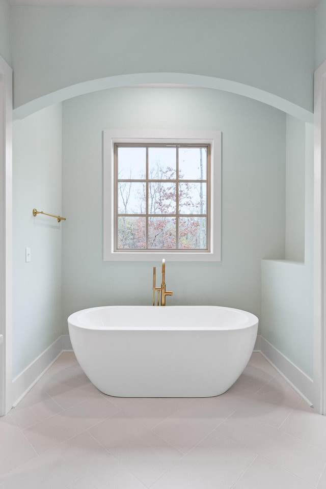 bathroom featuring tile patterned flooring and a bath