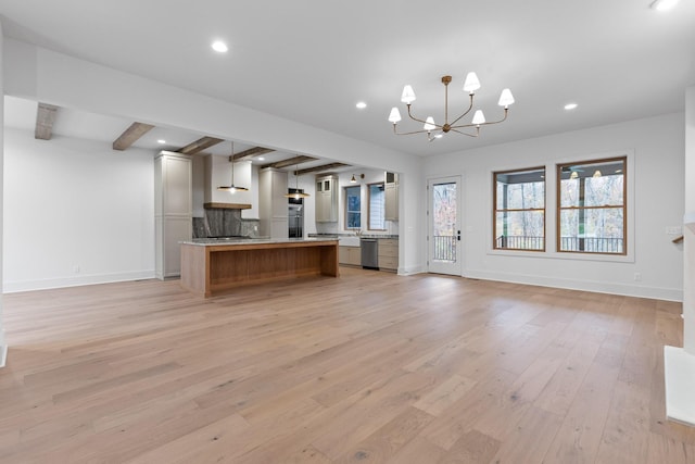 kitchen with open floor plan, stainless steel dishwasher, a chandelier, recessed lighting, and beam ceiling