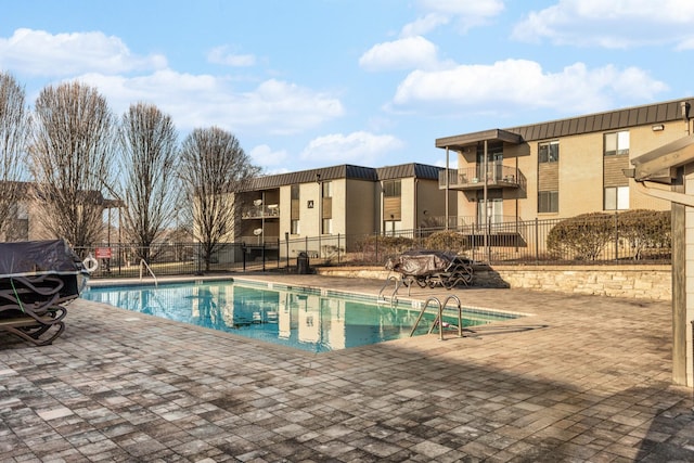 view of swimming pool with a patio