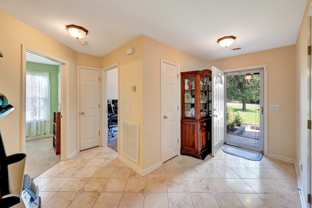 view of carpeted foyer entrance