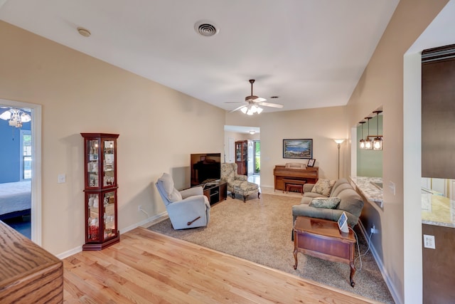 living room featuring plenty of natural light, ceiling fan, and light hardwood / wood-style flooring