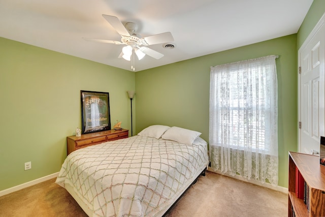 bedroom with ceiling fan and light colored carpet