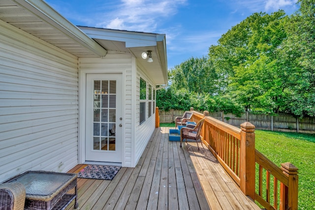 wooden terrace featuring a lawn