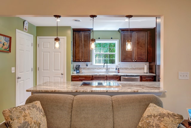 kitchen with sink, hanging light fixtures, a kitchen breakfast bar, stainless steel dishwasher, and black electric stovetop