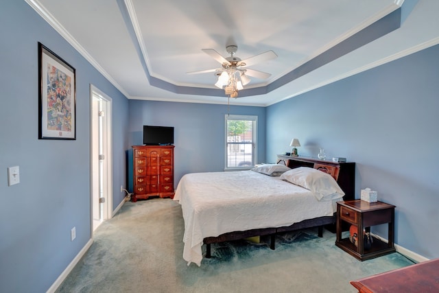 bedroom featuring ceiling fan, a raised ceiling, light carpet, and crown molding