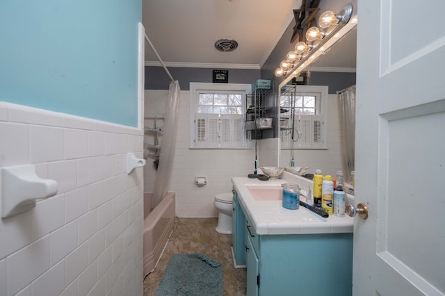 full bathroom featuring vanity, toilet, tile walls, and crown molding