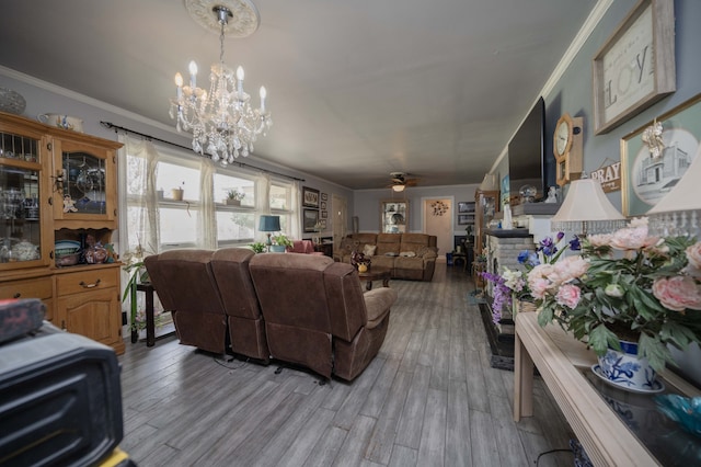 living room with crown molding, light hardwood / wood-style flooring, and ceiling fan with notable chandelier