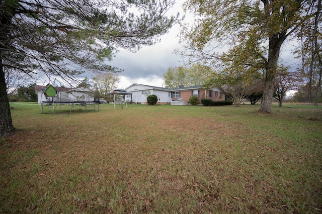 view of yard with a trampoline