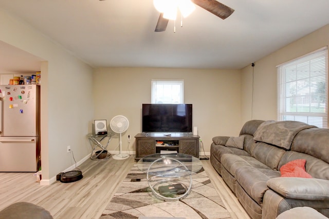 living room featuring light wood-type flooring and ceiling fan