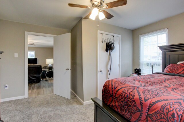 carpeted bedroom with a closet and ceiling fan