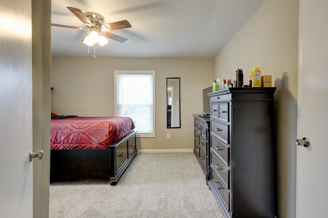 bedroom with ceiling fan and light carpet