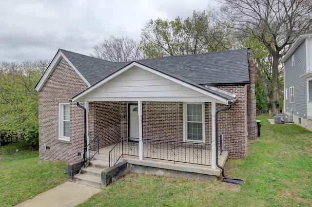 view of front of property featuring a front yard and central air condition unit