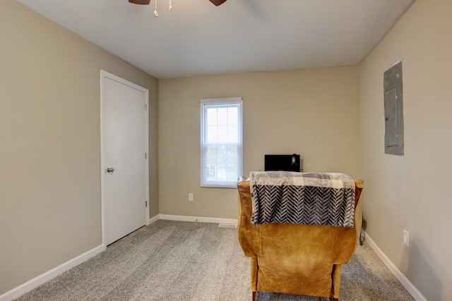 living area featuring ceiling fan, carpet, and electric panel