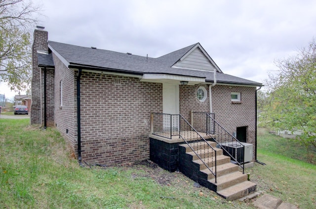 view of front facade with central AC and a front yard